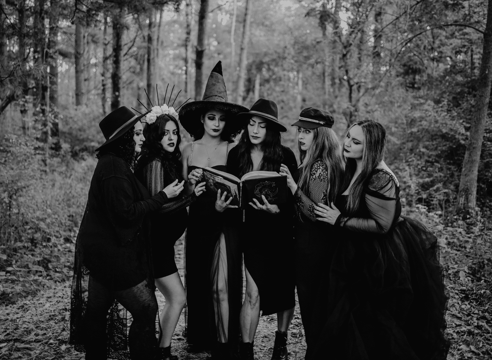 a group of women dressed up in witches costumes